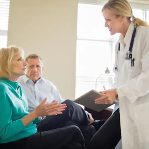Couple discussing patient care with doctor
