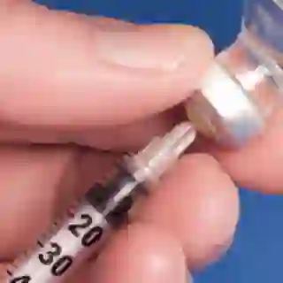 Syringe in hand.