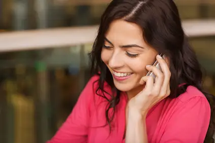 Smiling woman on cell phone.