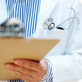 Doctor using clipboard