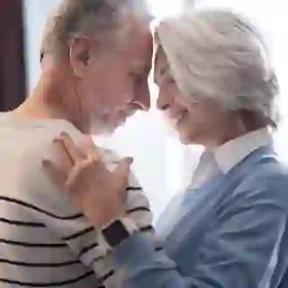 Elderly couple getting close and making eye contact