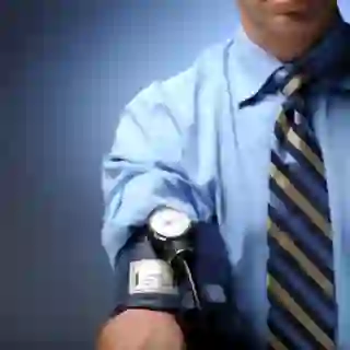 Man wearing blood pressure cuff on 