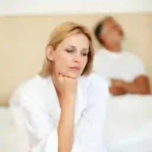 Wife and husband awake in bed.