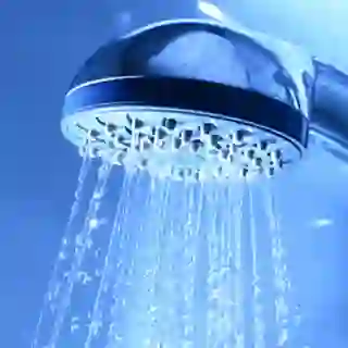 Shower head close up, water running.