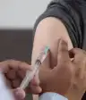 这是医生戴着手套接种疫苗的特写