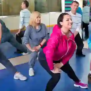 Women and men stretching in exercise class.