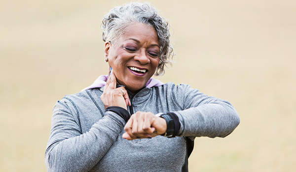 Active senior woman checking her pulse.