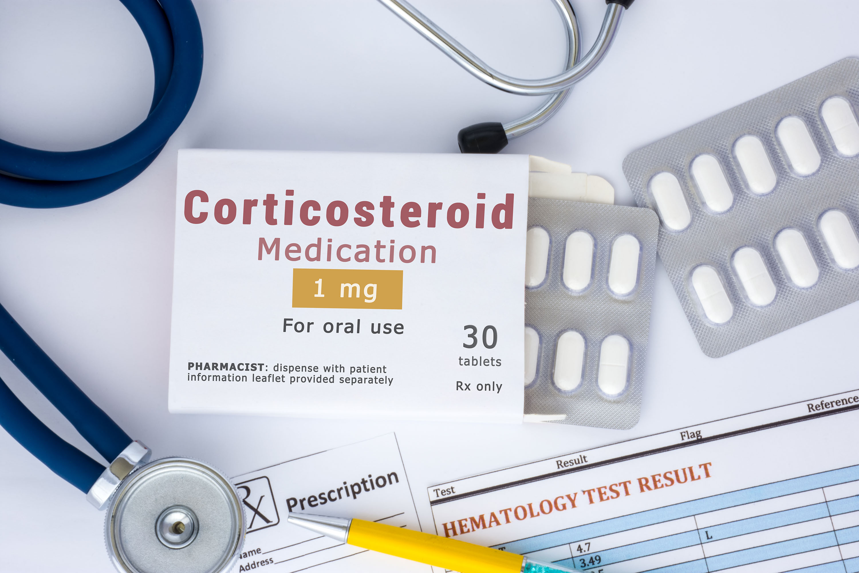 The image presents a medical scene focused on pharmaceutical prescriptions and healthcare diagnostics. A blister pack containing white, oval-shaped tablets is prominently displayed, alongside a prescription label reading 'Corticosteroid Medication' with a dosage of 1mg, intended for oral use. The label specifies a quantity of 30 tablets and requires a prescription ('Rx only'). A stethoscope, with its tubing in shades of blue and white, is partially visible, draped across the lower left corner, suggesting a clinical setting. Beneath the blister pack lies a prescription form with the word 'Prescription' clearly visible, and a yellow pencil rests on top of it, indicating active documentation. Further to the right, a 'Hematology Test Result' sheet is partially shown, displaying test results with numerical values (4.7, 3.49) and labeled columns for 'Test,' 'Result,' 'Flag,' and 'Reference.' The overall composition suggests a focus on medication management, diagnosis, and the process of healthcare delivery. The lighting is bright and clinical, emphasizing the sterile and professional nature of the scene. The arrangement of the items – medication, prescription, test results, and diagnostic tool – conveys a comprehensive view of patient care, from initial diagnosis to treatment and monitoring.