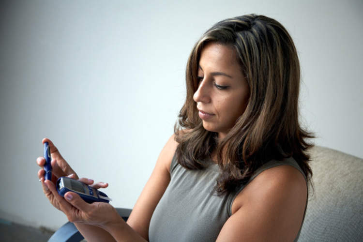 一个女人与糖尿病检查她的血糖水平。