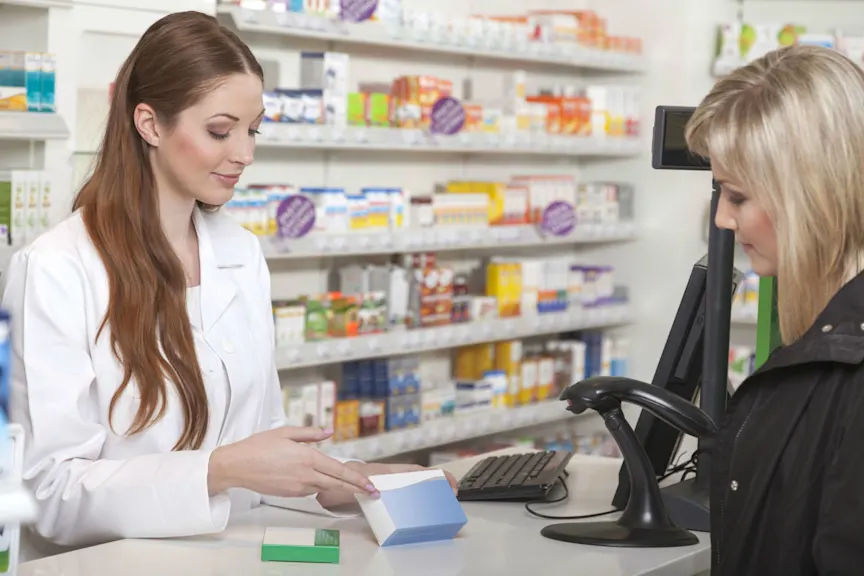 Pharmacists talking with woman