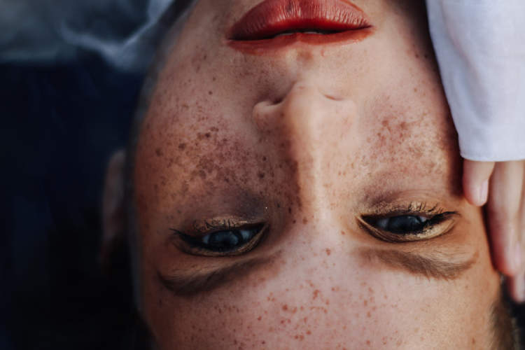 close up of woman's face with freckles