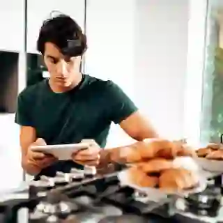 Man with tablet and food