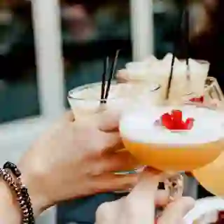 group of women cheers-ing cocktails
