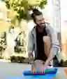 一个男人在外面卷起瑜伽垫