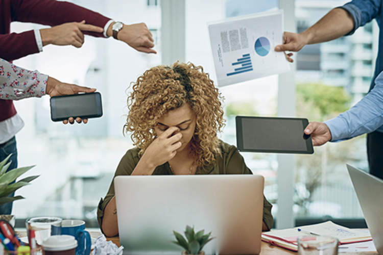 Woman stressed out by a heavy workload.