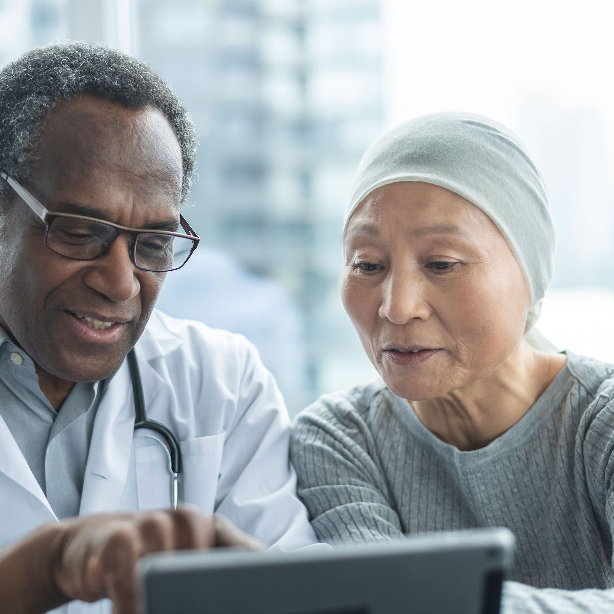 一位癌症患者和她的医生一起检查检查结果