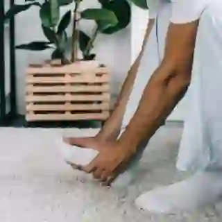 man touching foot, pain