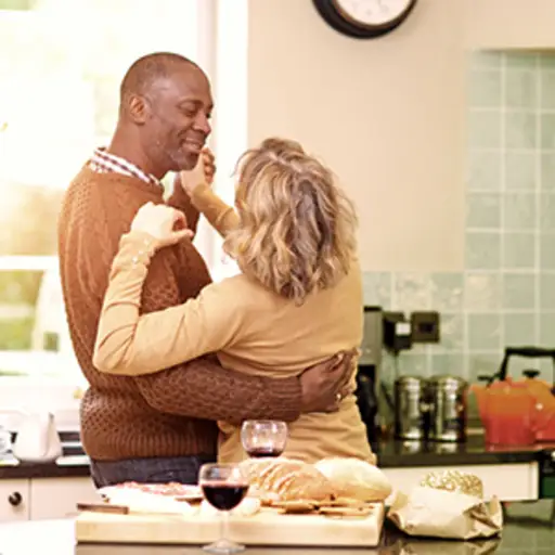 Mature couple dancing in the kitchen