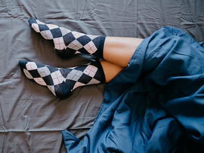 床上穿袜子的女人。