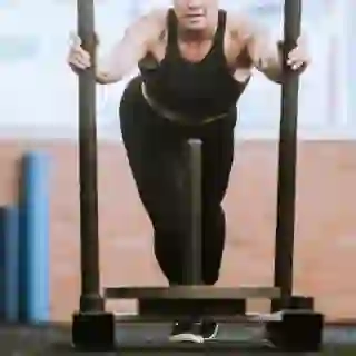 woman pushing weighted sled