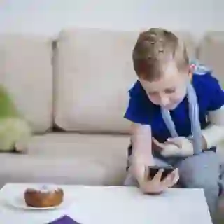 Boy with broken arm with mobile phone