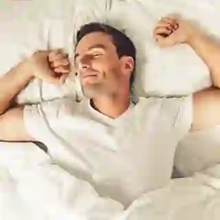 Middle-aged man waking up in bed image.