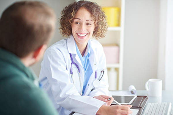 Doctor laughing with her patient.