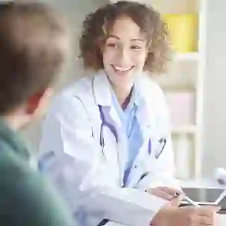 Doctor laughing with her patient.