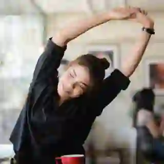 Woman stretching at desk