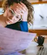 Woman worried about health care costs with medical insurance form.