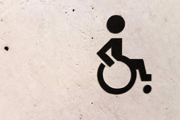 残疾人符号在墙上喷涂轮椅上的人
