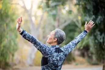 Senior woman stretching her back and shoulders.