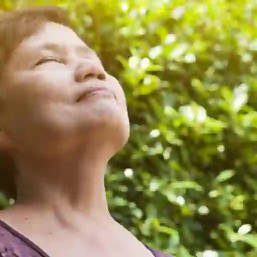 Older woman well rested outside.