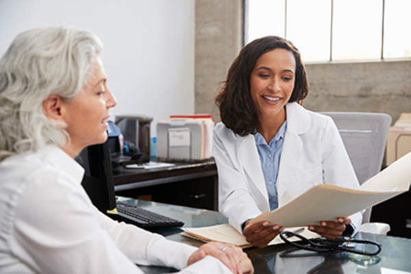 Friendly doctor explaining information to a patient.