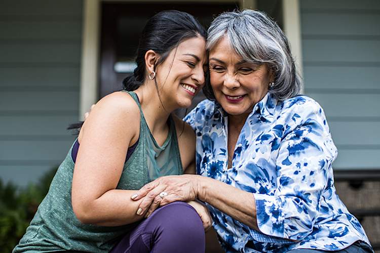 Senior mother and daughter laughing together.