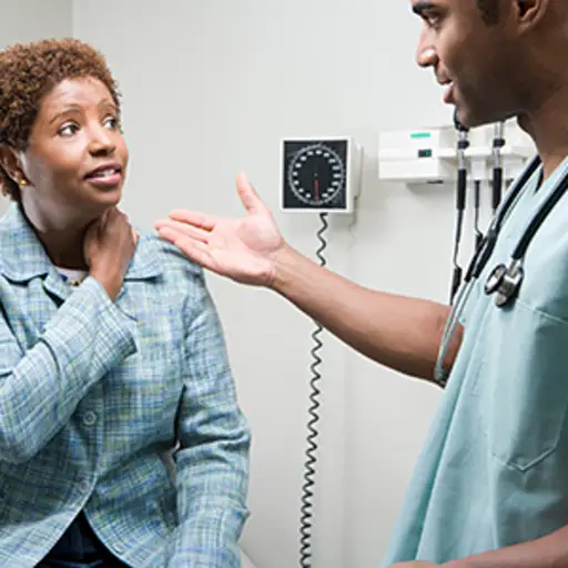 妇女咨询她的医生关于脖子痛。