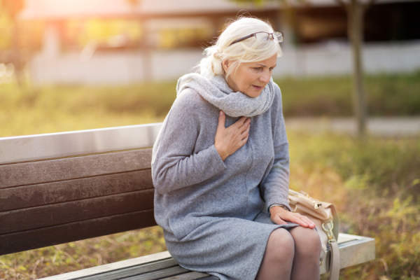 老妇人紧抓着心脏坐在外面
