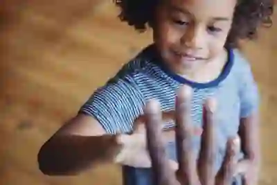 child looking at adult hand