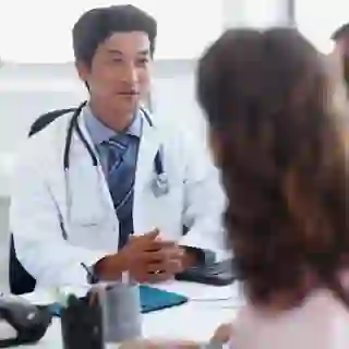 Couple talking to a doctor together.