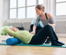 older woman exercising with trainer
