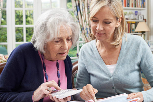 成年女性帮助一位资深的女人财政。