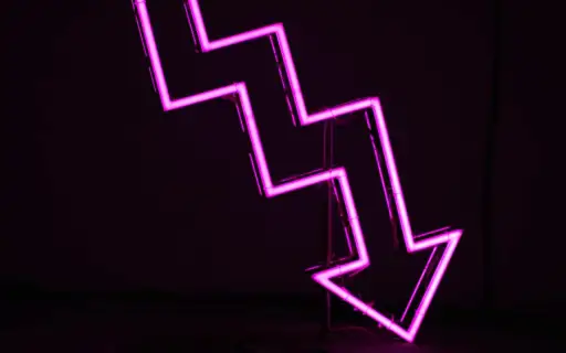 neon sign with arrow pointing down