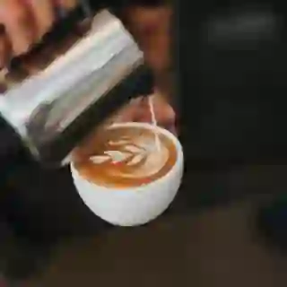 barista pouring latte