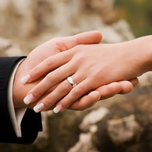Bride and groom holding hands.