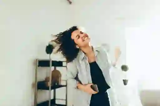 woman dancing while listening to headphones