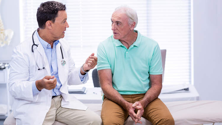 一名老年男子与医生讨论前列腺癌的治疗方案。
