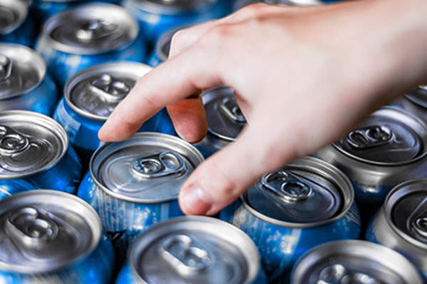 Reaching for a can of soda.