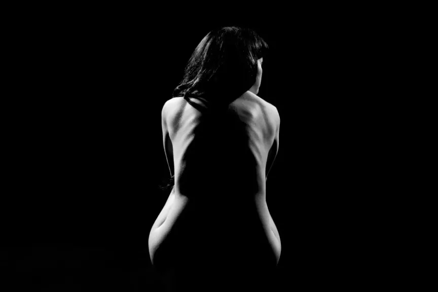 黑白照片的裸体女人和阴影垂下脊柱