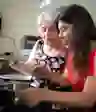 A grandmother cooks with her granddaughter