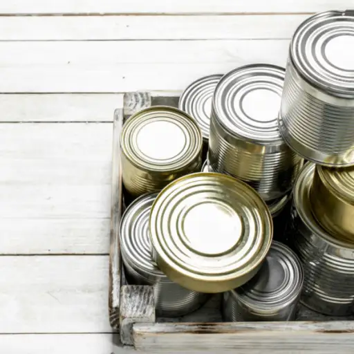 Tin cans with food in a box